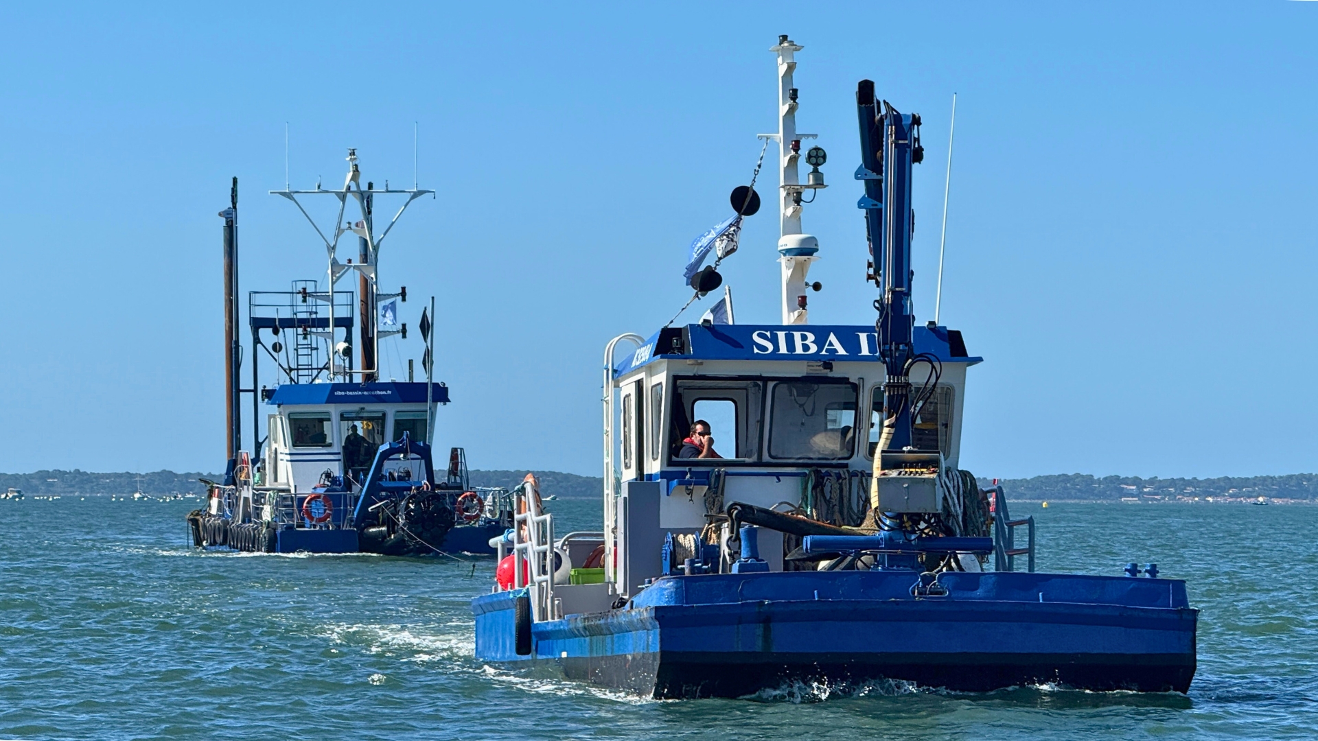 2 bateaux bleu et blanc (remorqueur siba II et drague Dragon) dans le bassin d'arcachon