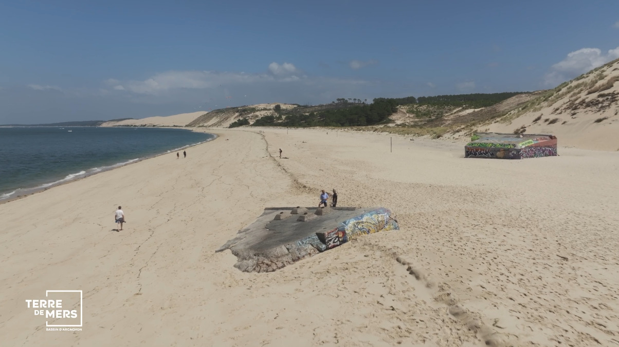 plage avec un blockhaus. Texte : logo Terre de Mers