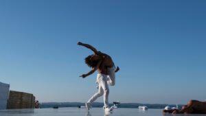 danseurs sur scène avec la plage d'arcachon en arrière plan