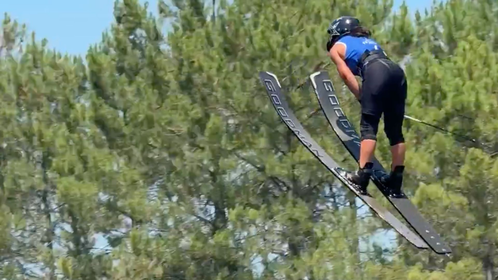 une femme vol dans les airs en ski nautique. de spins derrièreselle.