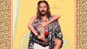bob sinclar : homme avec une chemise léopard et un pantalon blanc. Une femme enlacée à lui en arrière plan