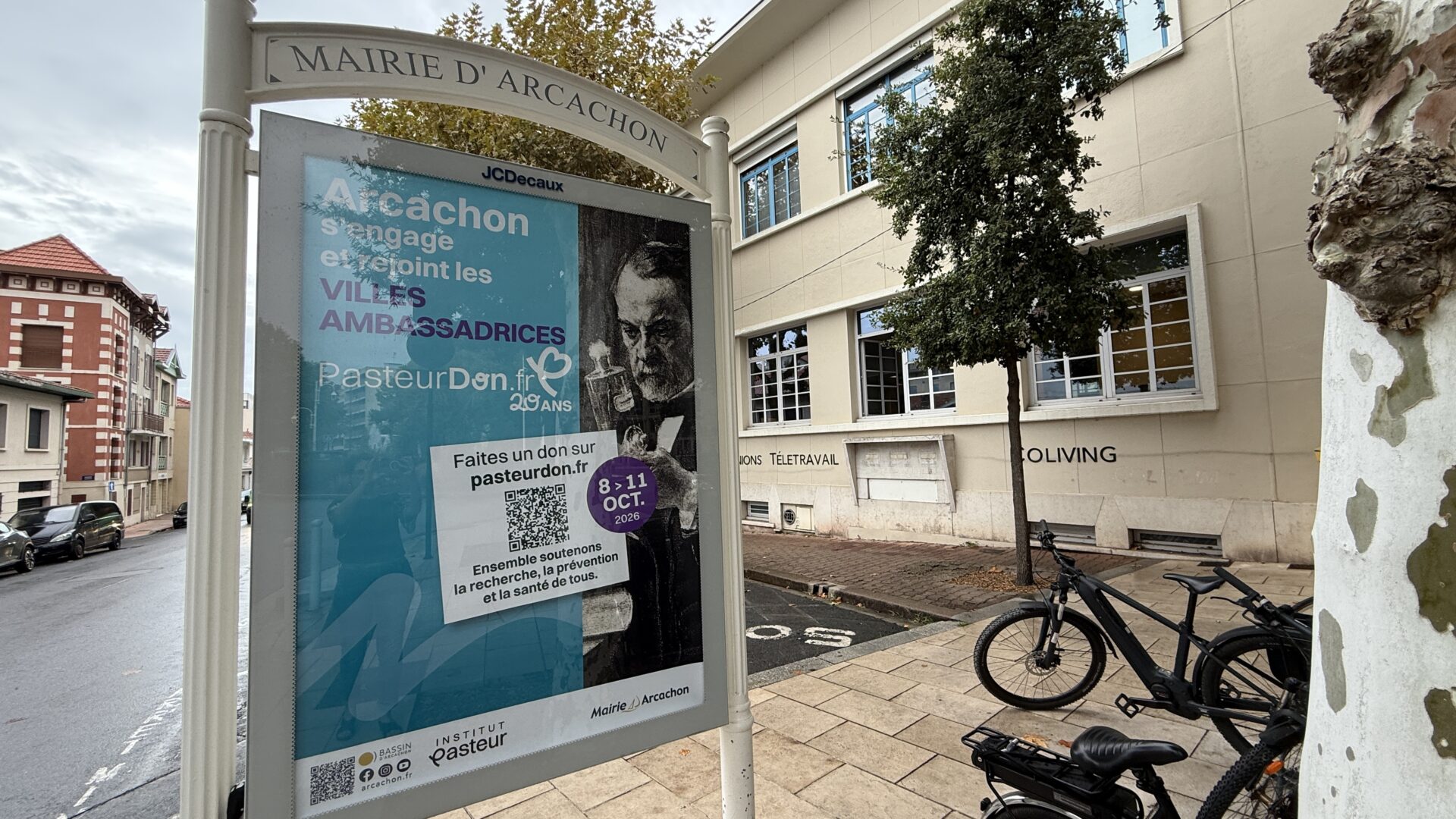 un panneau d'affichage en ville avec une affiche en faveur du pasteur don